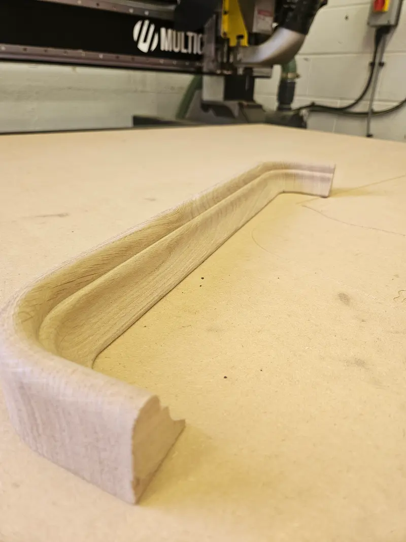 Curved profile routed into an MDF sheet on the CNC