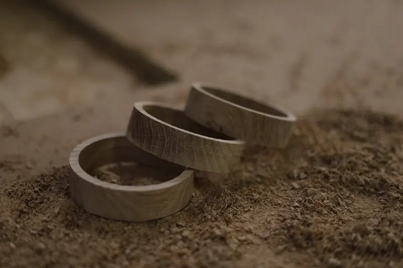 Three turned timber rings resting in sawdust